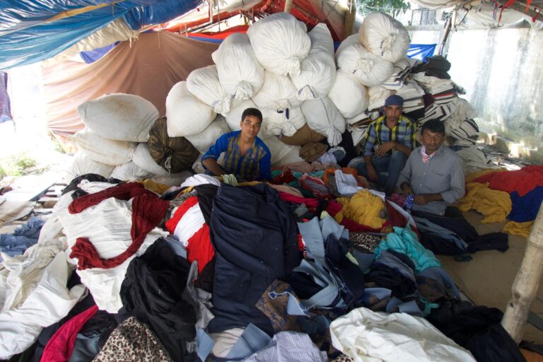 Men sorting textile waste in Dhaka