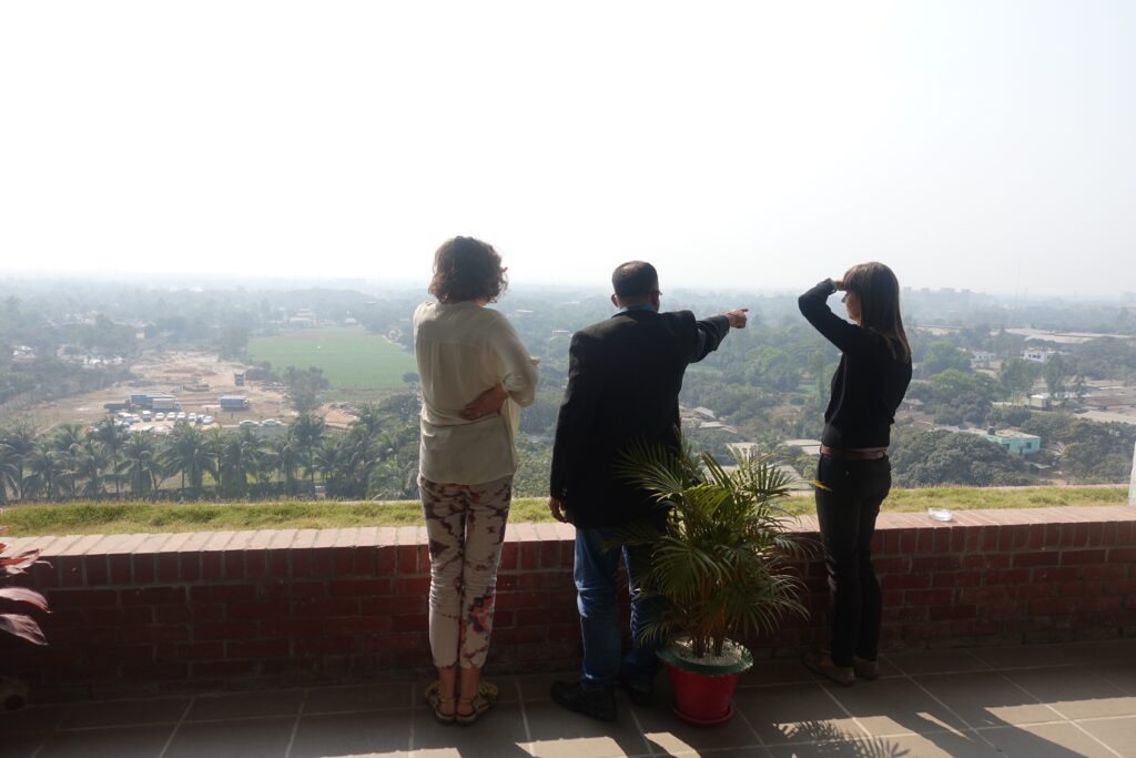 Nin and Kadri on a hill in Dhaka looking over the premises one of the key suppliers of H&M