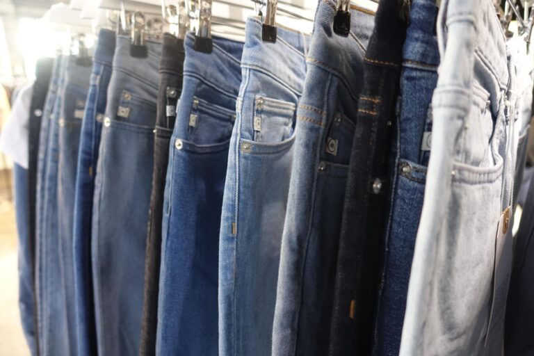 Pairs of blue jeans on hangers