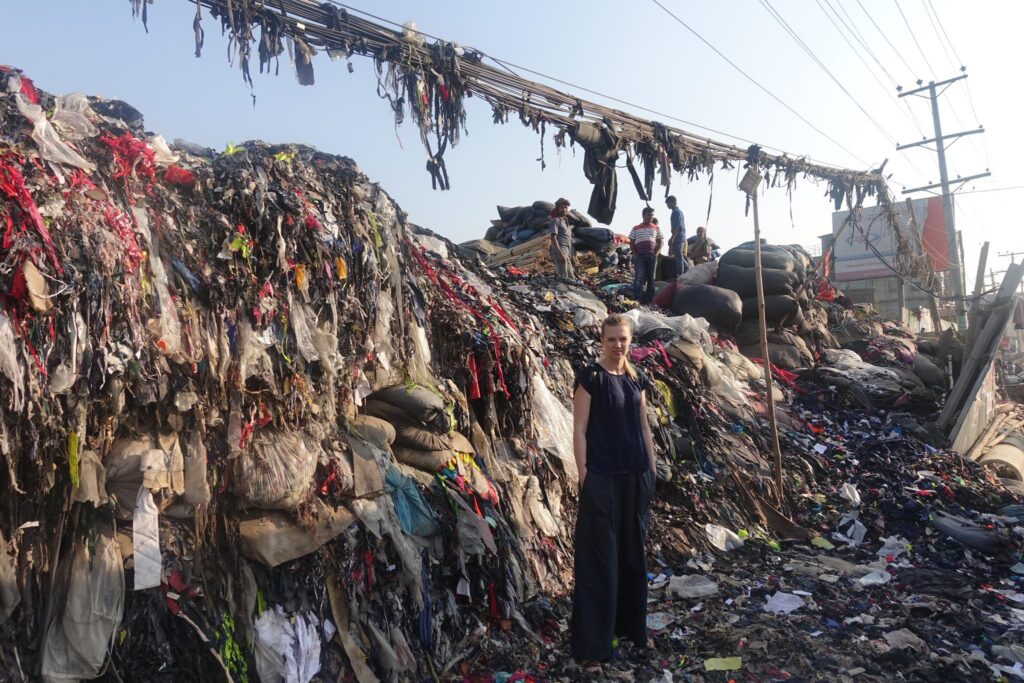 Ann Runnel in Dhaka, standing in front of one of the waste dumping sites of an EPZ area.
